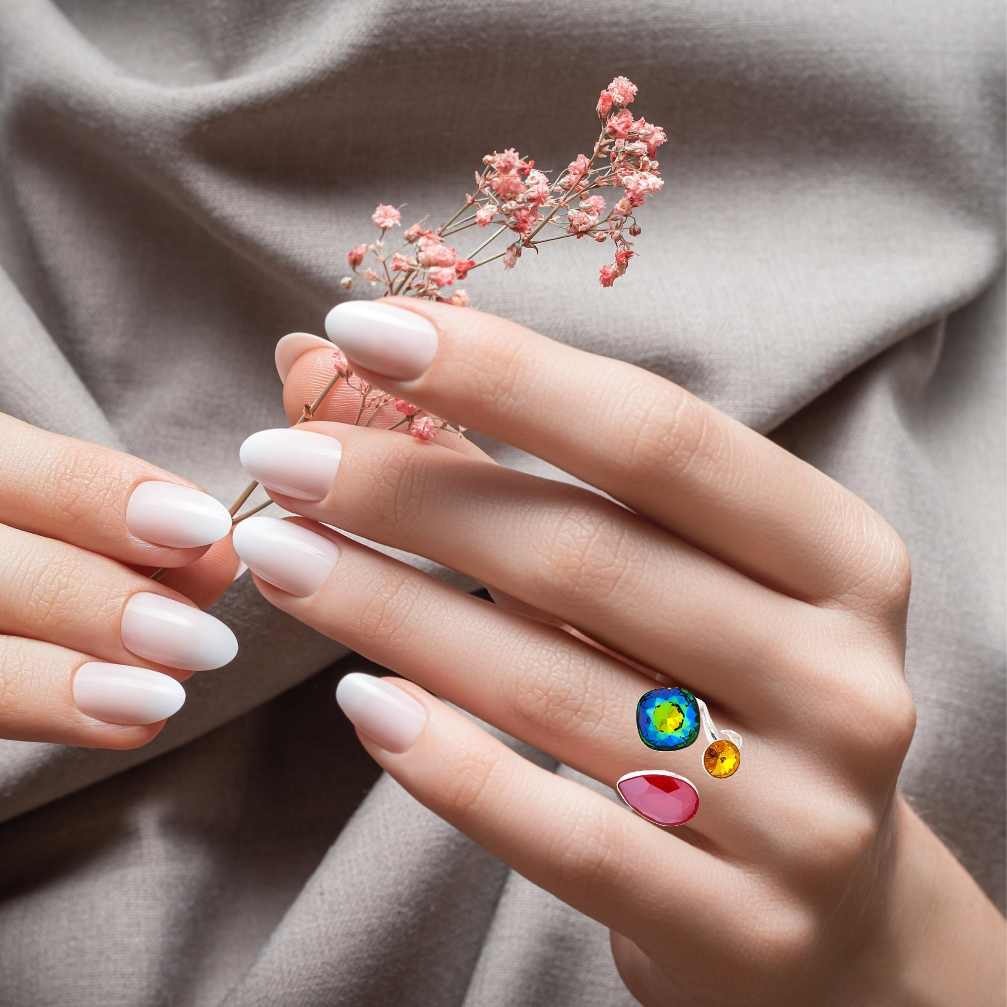 Women's hands elegantly presenting the Spectrum Splendour Adjustable Ring by Magpie Gems, highlighting its bold, multi-coloured crystals.