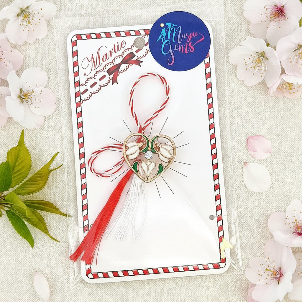 Packaged 'Heart of Spring' Snowdrops Martisor brooch from Magpie Gems, ready for gifting with traditional red and white string.