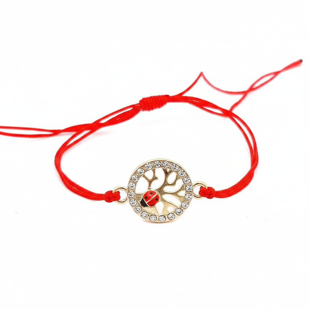 Exquisite 'Vitality Spark' Martisor Bracelet with a gold-plated Tree of Life charm adorned with a ladybird and crystals on a vibrant red adjustable cord. Handmade in Ireland