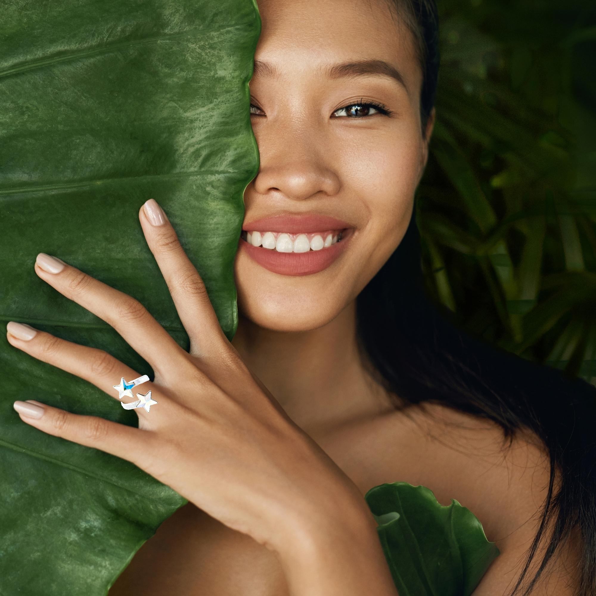 Woman's hand gracefully showcasing the Gemini Stars Ring with sparkling Crystal AB Star Crystals - Magpie Gems Ireland