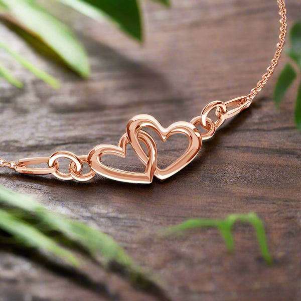 Our hearts as one - Introducing the Rosegold Plated Sterling Silver Necklace with Intertwined Heart Pendant, a stunning piece of jewelry that perfectly captures the essence of love and romance.