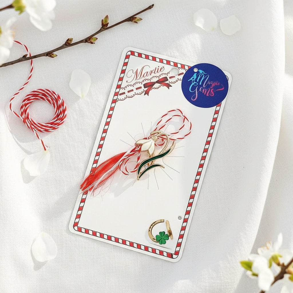 The 'Emerging Snowdrop' Martisor brooch, presented with the red and white Martisor string, symbolising the beginning of spring with a Martisor's story card and clear bag ready for gift giving on 1st of March.