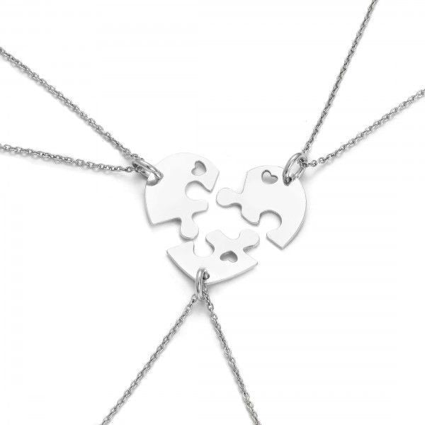 Three sterling silver puzzle pieces with heart cut-outs, coming together to form a full heart, representing Magpie Gems' Heart of Unity Puzzle Necklace.