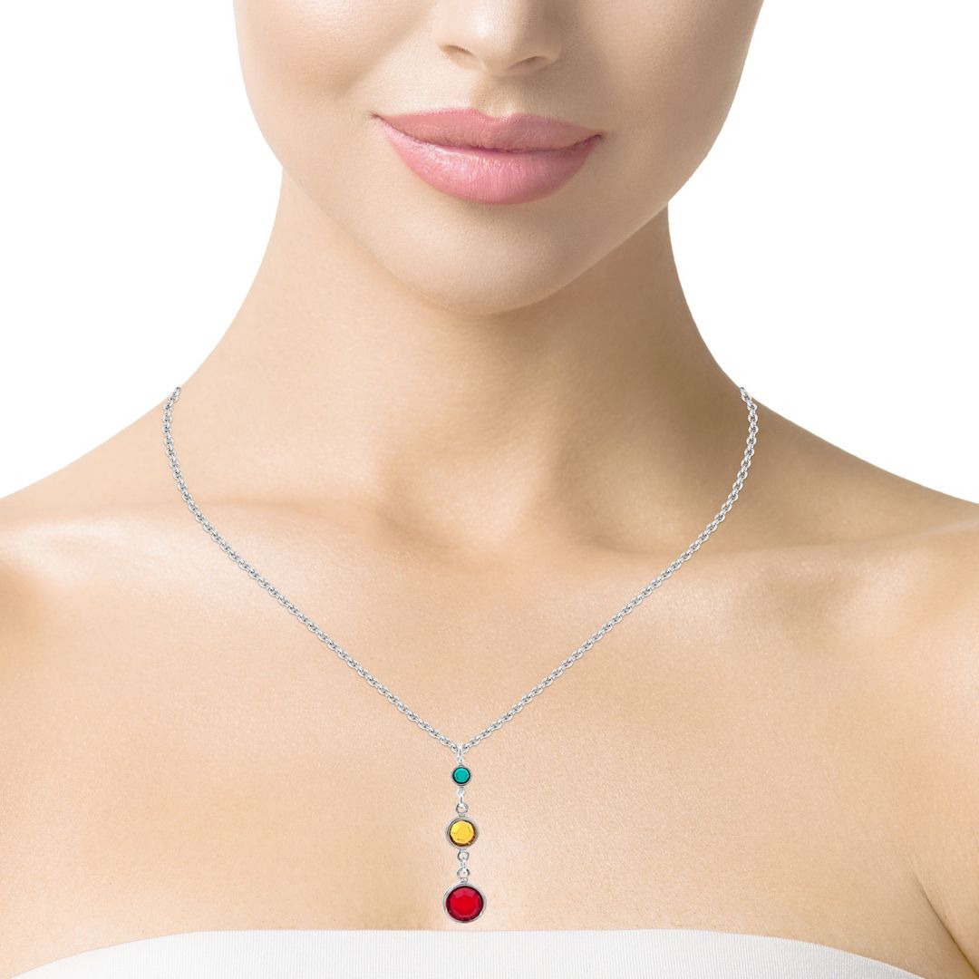 Women wearing a sterling silver necklace with tiered birthstones representing three generations, featuring Astrian birthstone crystals in varying sizes, hadnmade in Ireland.