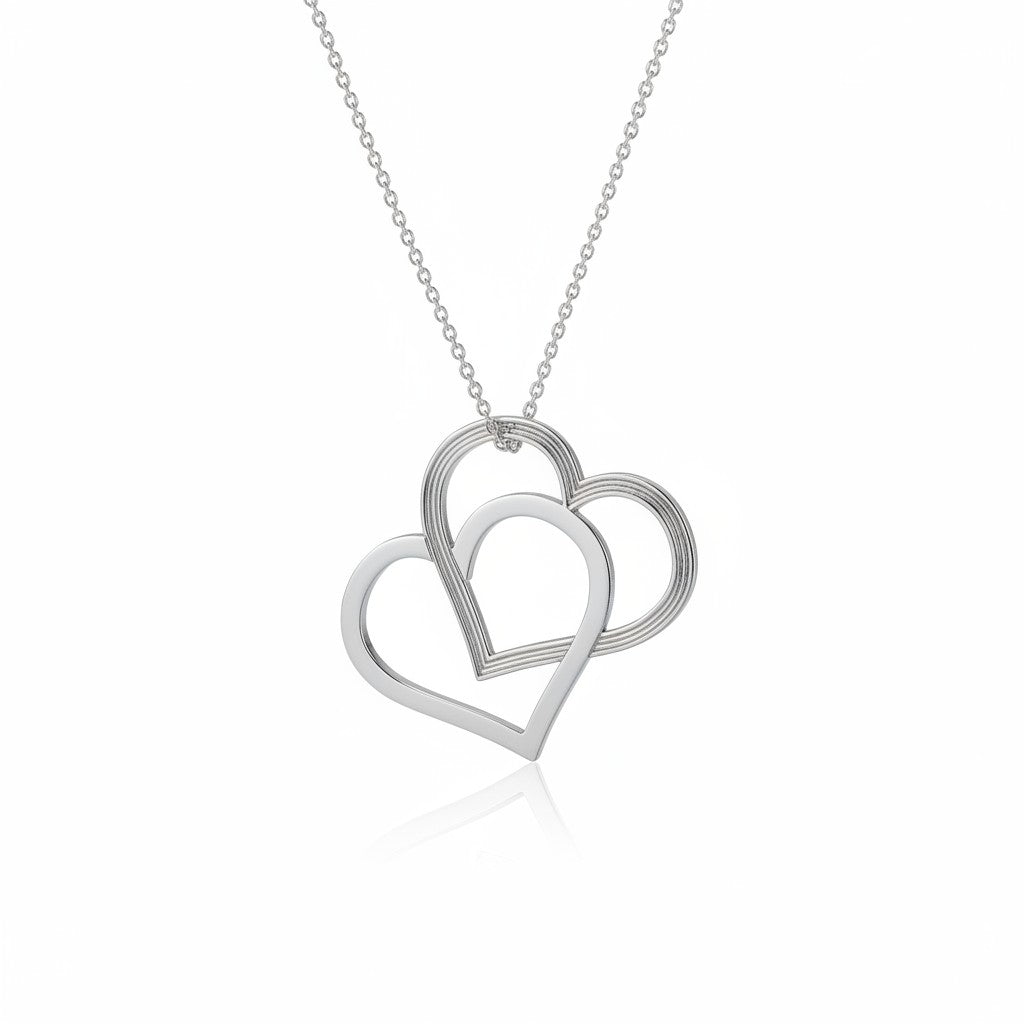 Shimmering silver necklace with two intertwined heart pendants hanging from a delicate chain, made in Ireland