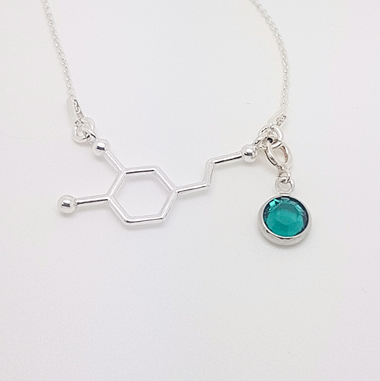 Dopamine Molecule Necklace: A striking representation of the dopamine molecule pendant in sterling silver with a birthstone charm of your choice