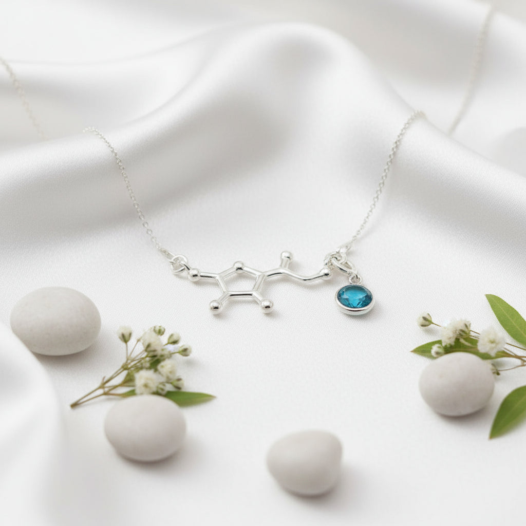 Silver Vitamin C molecule pendant with removable December blue birthstone charm, unique science-inspired necklace by Magpie Gems.