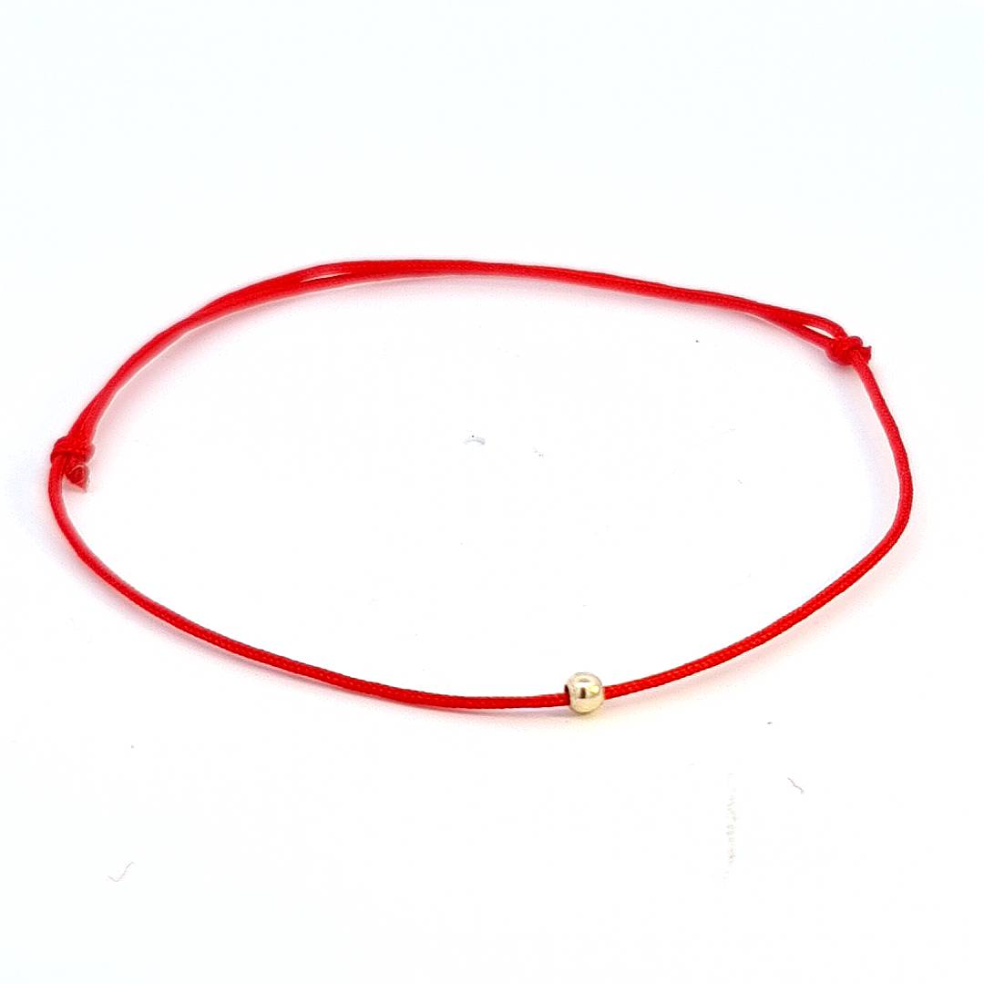 Eternal Crimson Thread Bracelet featuring a luminous 14k solid gold bead centrepiece on a vivid red string, handcrafted in Ireland.