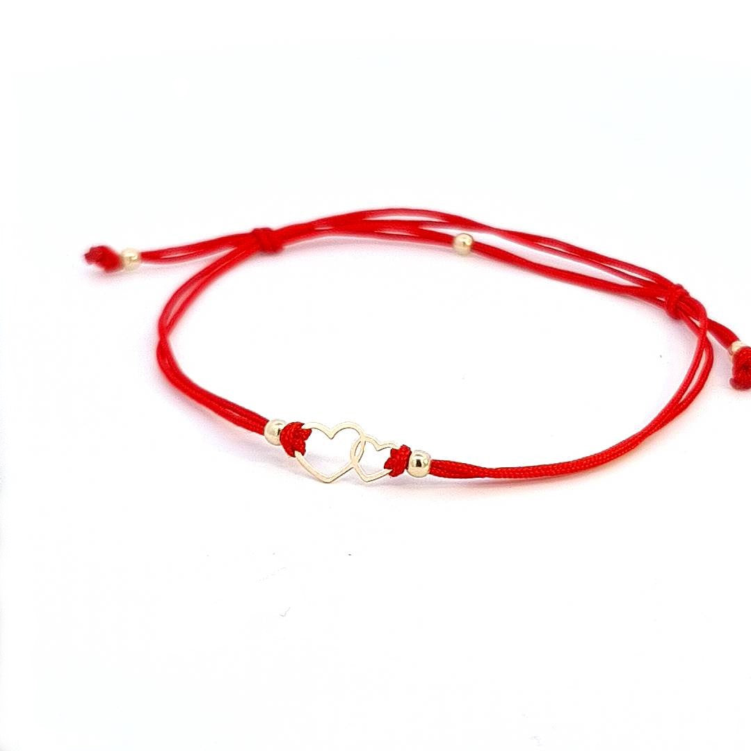 Alternate side view illustrating the adjustable red string design of the Hearts of Harmony Gold Bracelet.