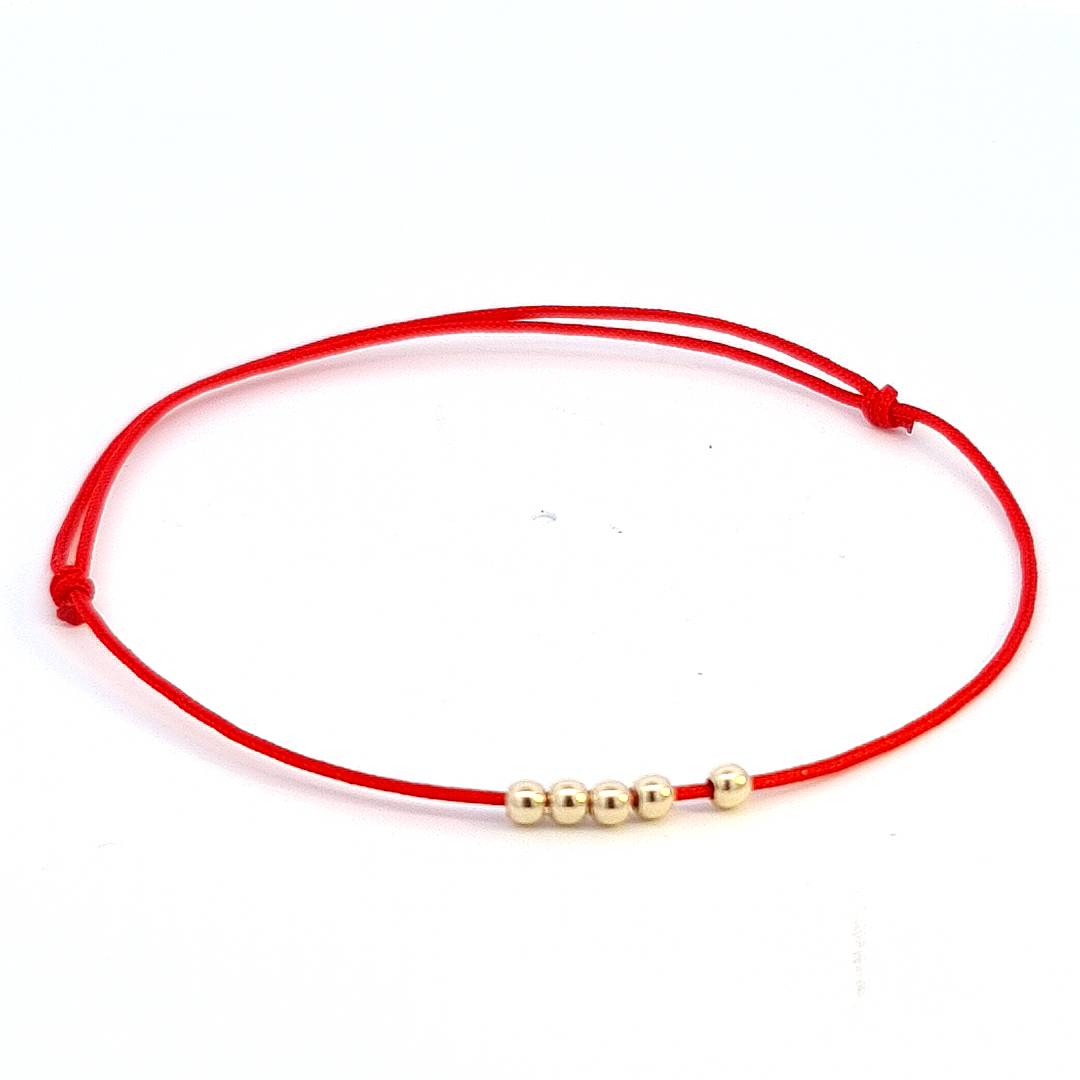 The 'Quintessence Circle' Bracelet front view with five evenly spaced 14k gold beads against the Magpie Gems signature red string.