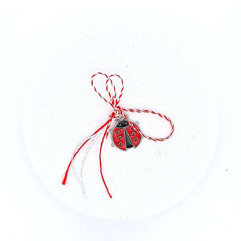 Front view of the large silver ladybug Martisor charm with a red and white bow, part of the 'Ladybug Whispers' collection.