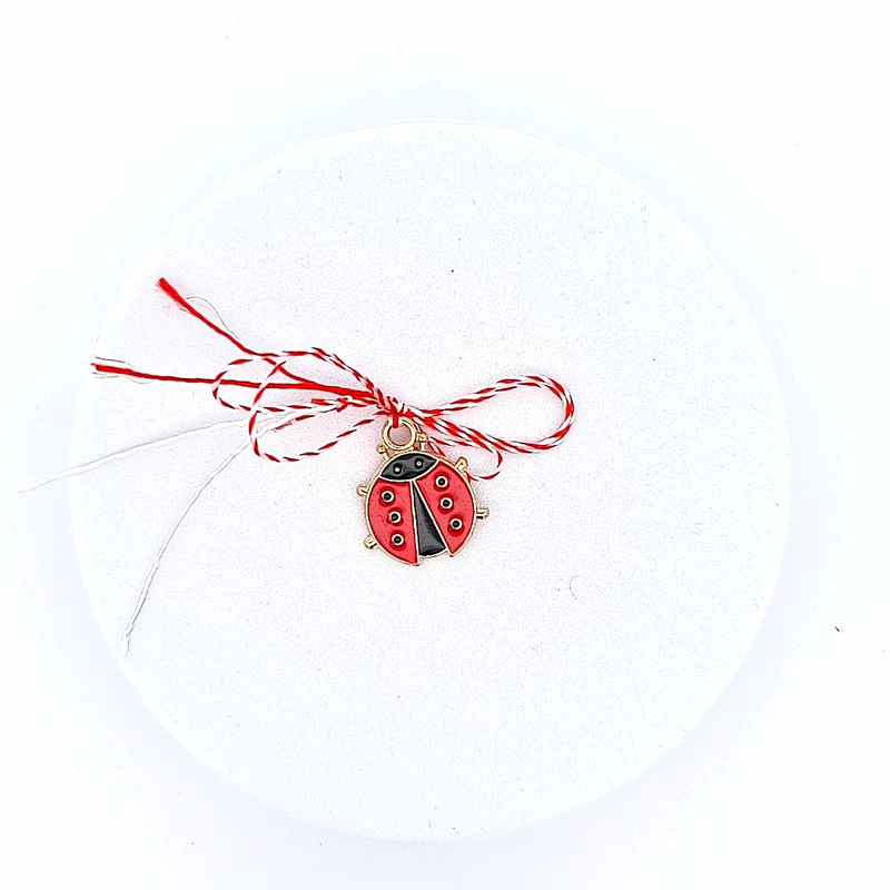 Front view of the large gold ladybug Martisor charm from the 'Ladybug Whispers' collection for children.