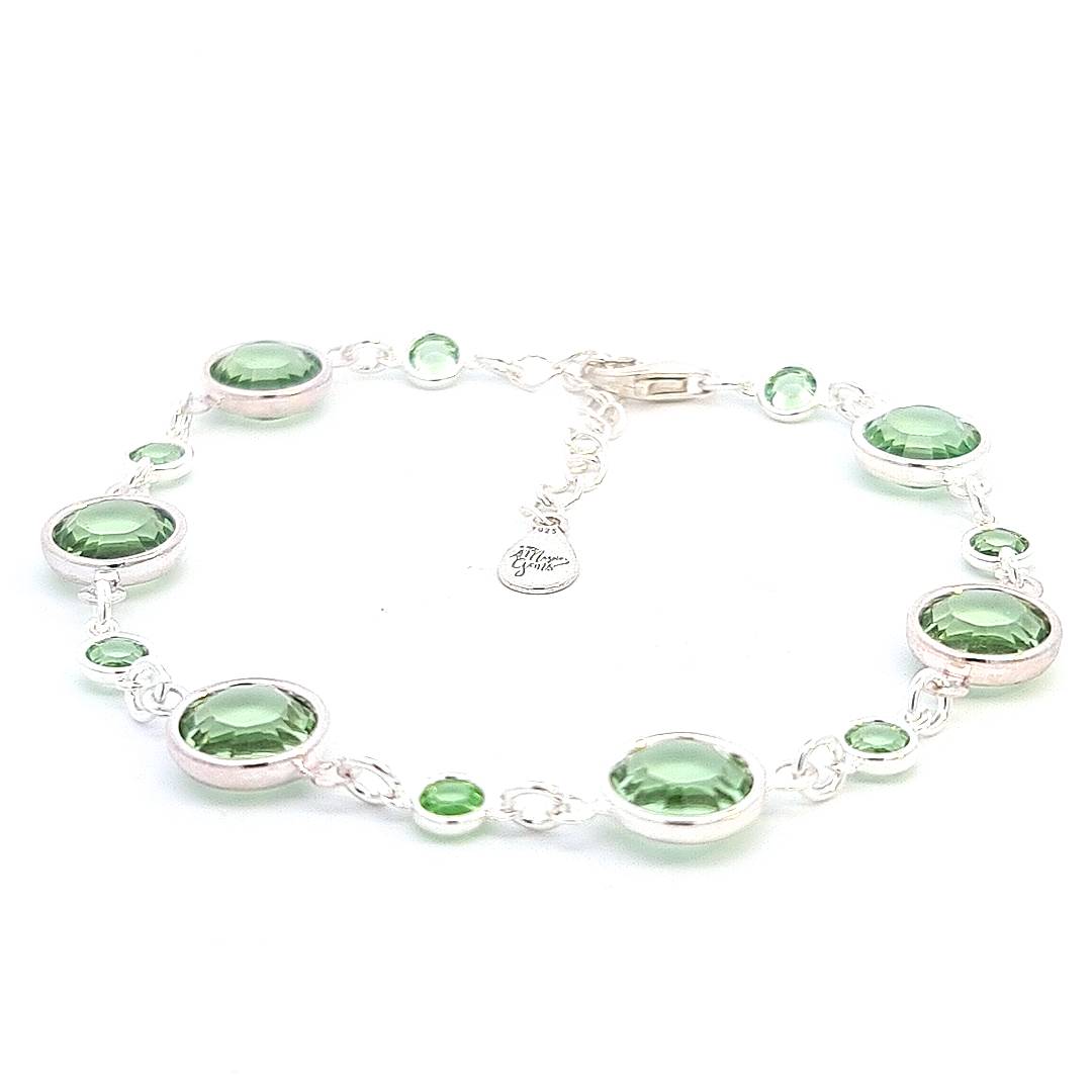 August birthstone handcrafted bracelet in sterling silver, featuring peridot crystal links that glitter with a light green hue, representing prosperity, from Ireland.