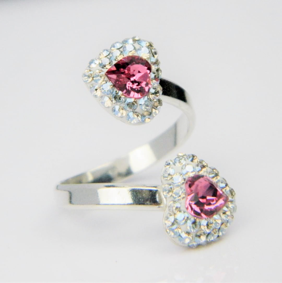 Magpie Gems sterling silver double heart pave ring with pink Austrian crystal accents, showcasing artisanal Irish craftsmanship.