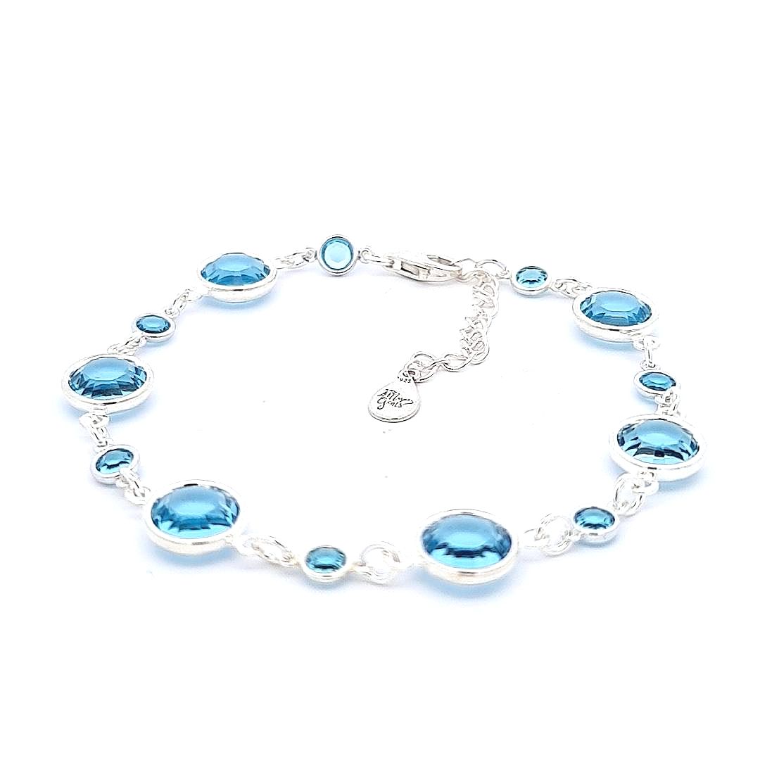 Artisanal March birthstone bracelet with sterling silver links, each inlaid with aquamarine crystals symbolizing tranquility, lovingly created in Ireland.