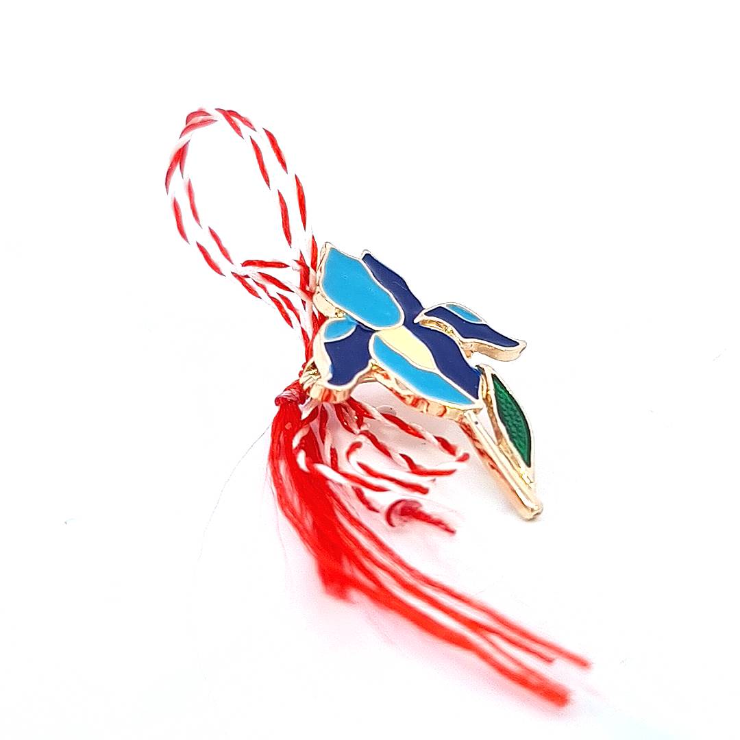 Side view of the 'Blue Iris Enchantment' Martisor brooch, highlighting the contrast between the glossy enamel and the gold-plated edges.