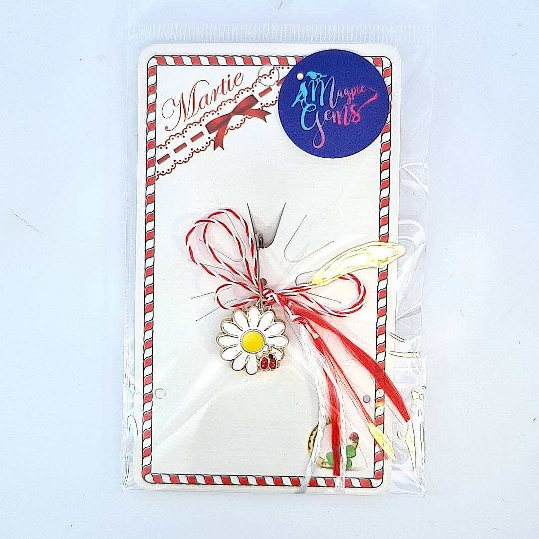 Gold-plated 'Sunny Bloom' Martisor charm placed on a storytelling card with Martisor's legend, perfect for springtime traditions.