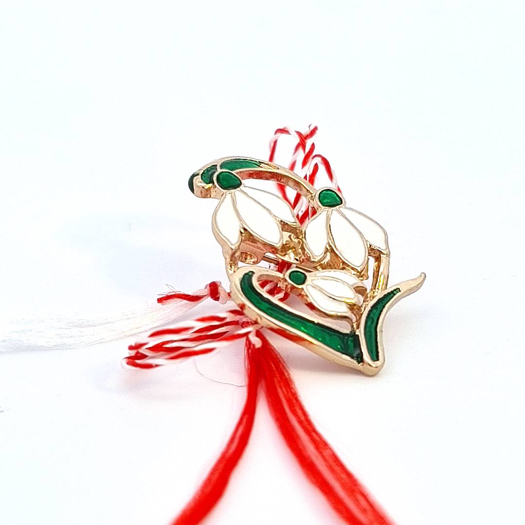 Cultural heritage symbol - Magpie Gems' Martisor snowdrop brooch with red and white string bow.