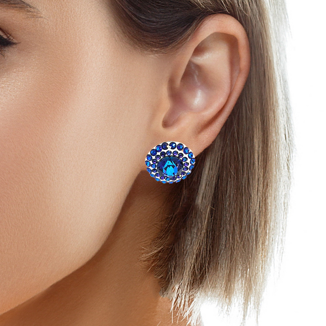 Elegant woman wearing Celestial Halo heliotrope crystal stud earrings, radiating sophistication and timeless beauty. from Ireland