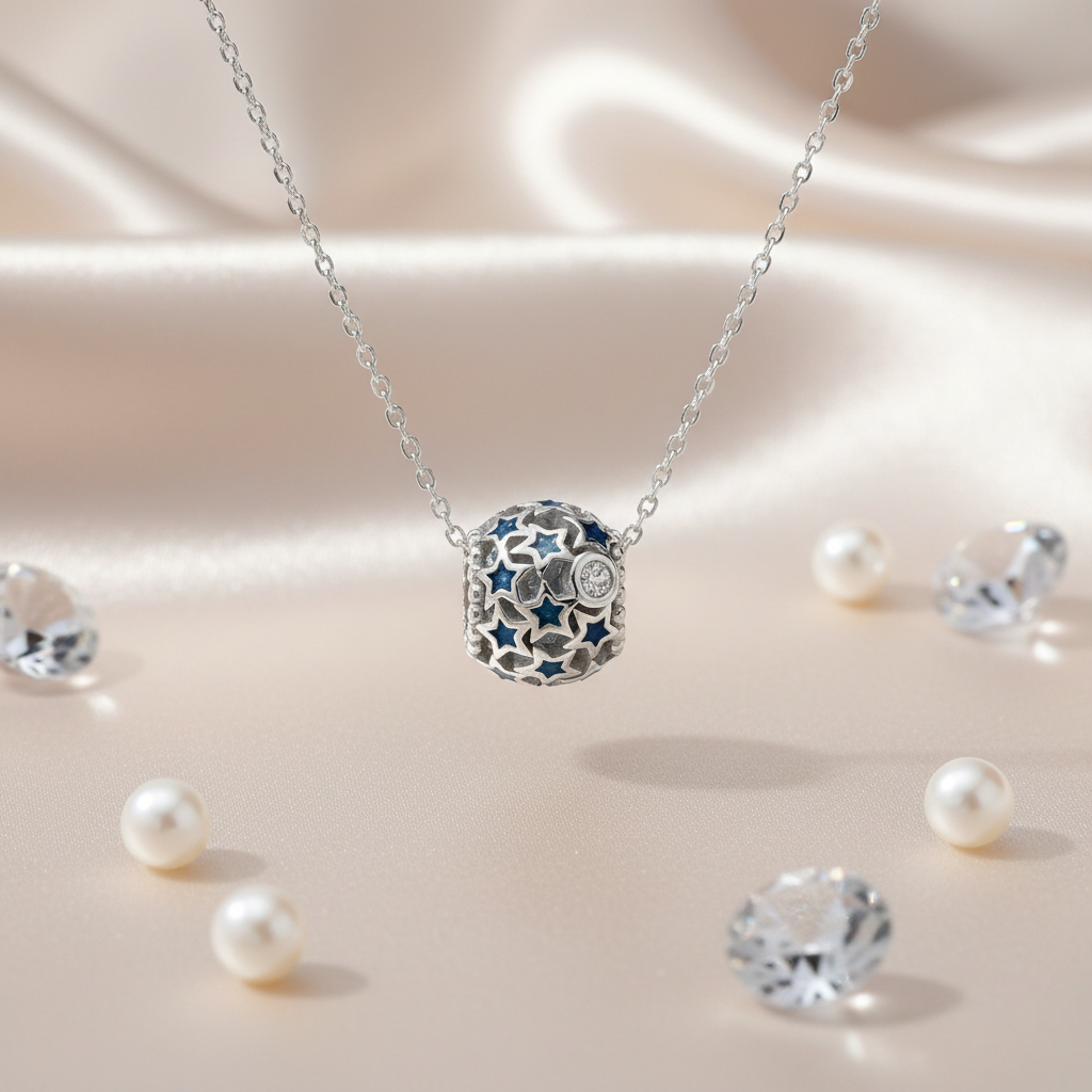 Close-up of a sterling silver celestial sphere necklace with star cut-outs and blue crystals, displayed on satin with pearls and crystals, handcrafted by Magpie Gems.