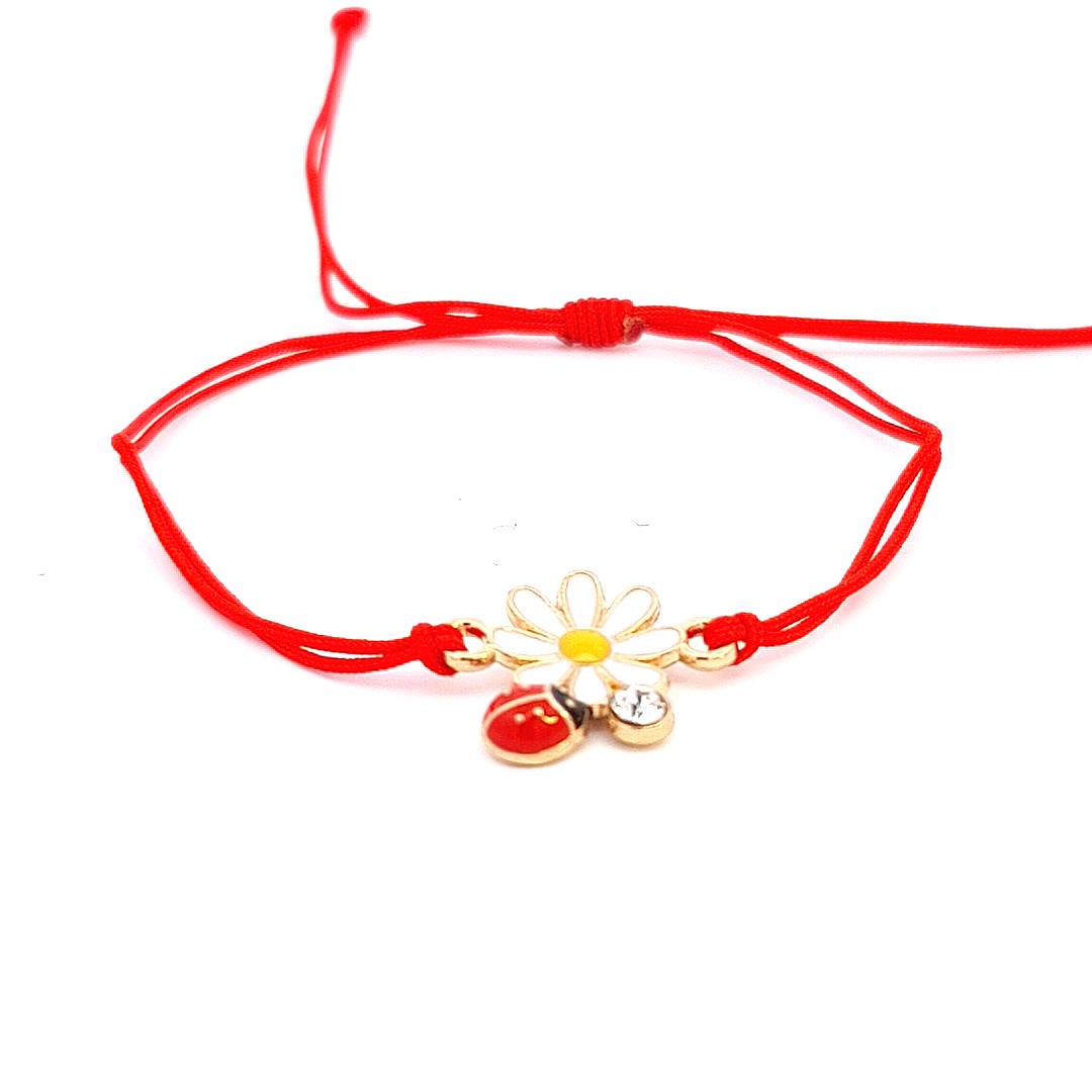 Flower and Ladybird Martisor Bracelet on a white background, showcasing the brass white flower charm, red ladybird detail, and adjustable red macramé cord.
