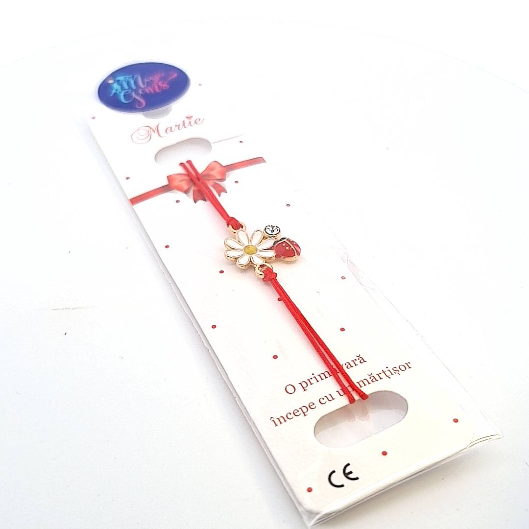 Flower and Ladybird Martisor Bracelet presented on a branded paper card and inside a clear gift bag, ready for giving. Handmade in Ireland