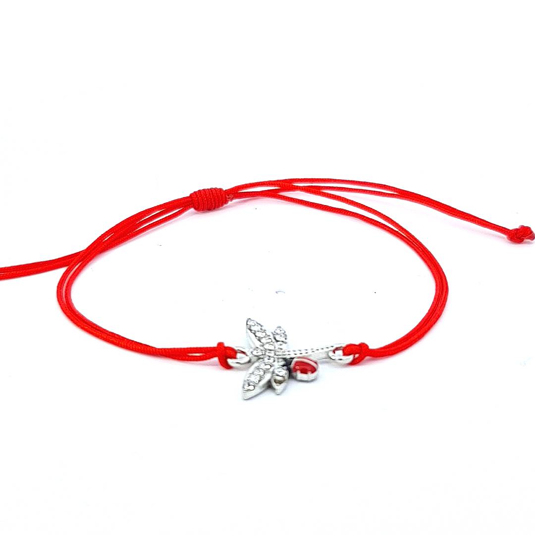 Delicate 'Whispers of Spring' Martisor Bracelet with a crystal-studded dragonfly and red ladybird charm, tied on a red adjustable macramé cord, showcased against a white background.