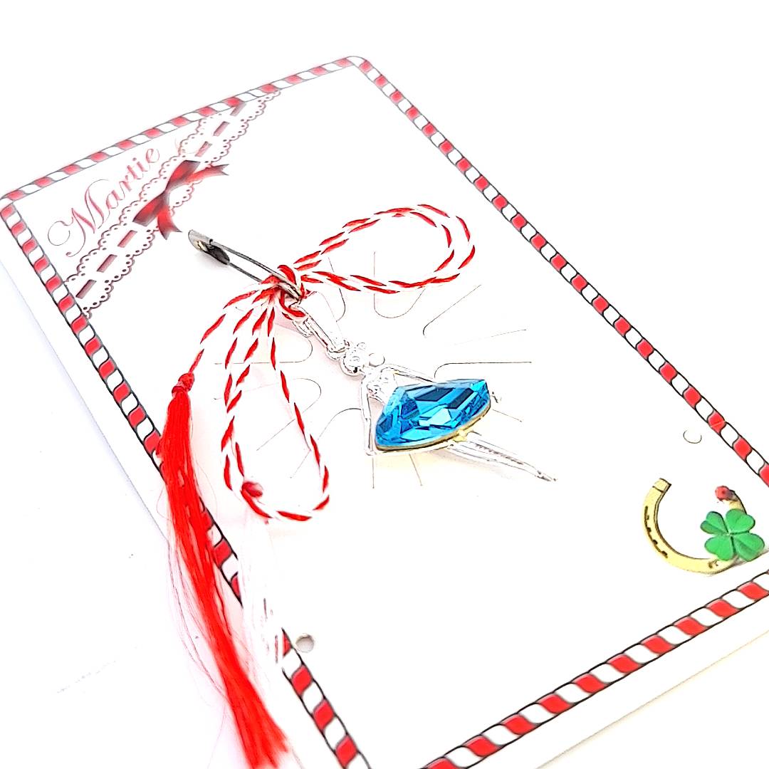 The Graceful Rhapsody Ballerina Mărțișor Pendant elegantly presented on a storytelling card, adorned with a red and white string representing health and happiness handmade in Ireland.