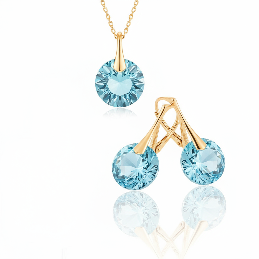 Gold-plated March birthstone jewellery set with faceted Aquamarine blue Austrian crystal drop earrings and coordinating pendant, handmade in Ireland by Magpie Gems.