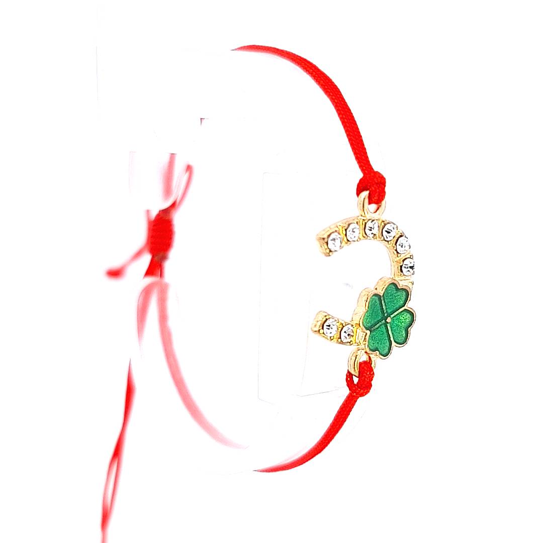 Side view, Close-up of the 'Fortune's Embrace' Martisor Bracelet being worn, highlighting the gold horseshoe and clover charms against the white background.