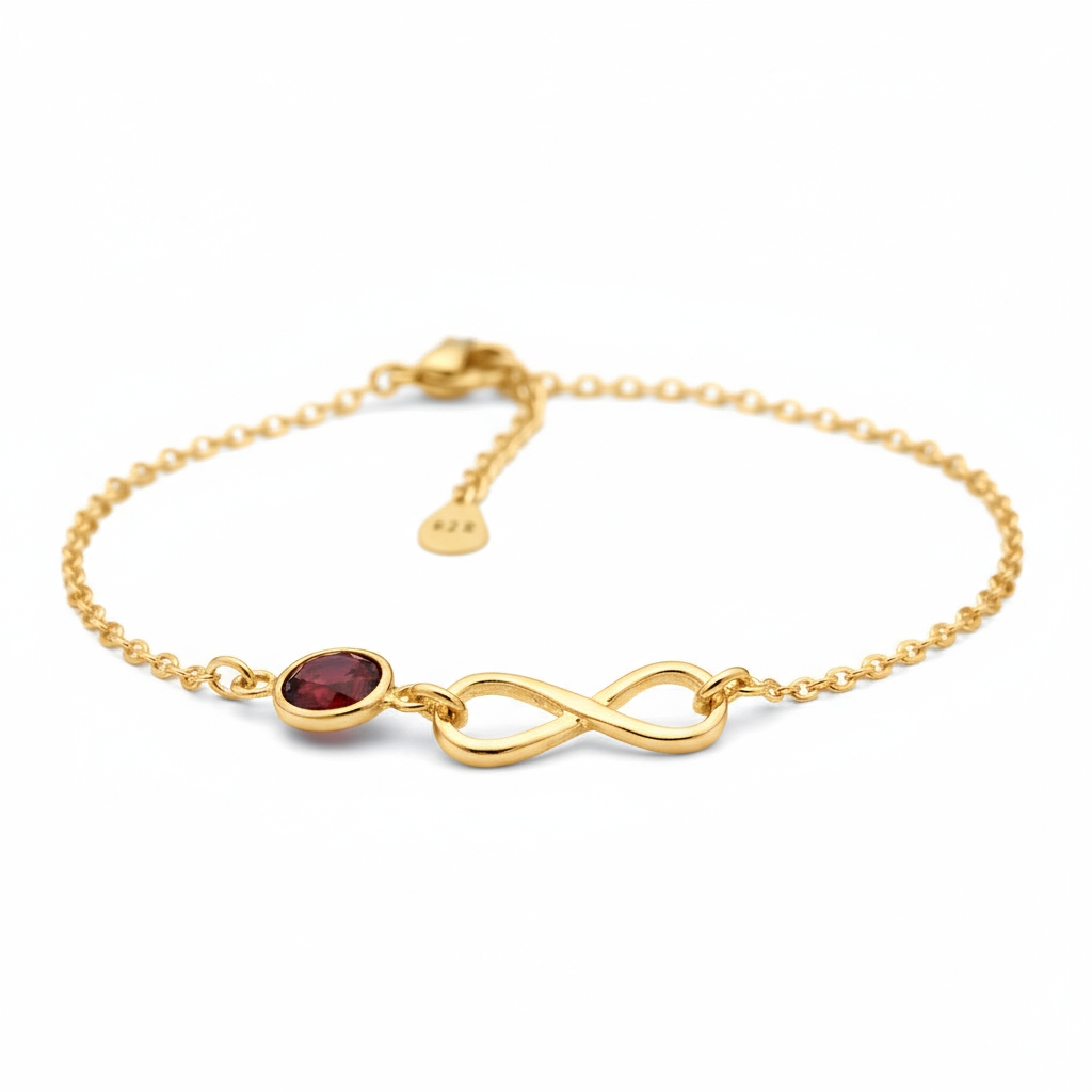 Gold over sterling silver bracelet for women with a red July birthstone and infinity symbol on a white background