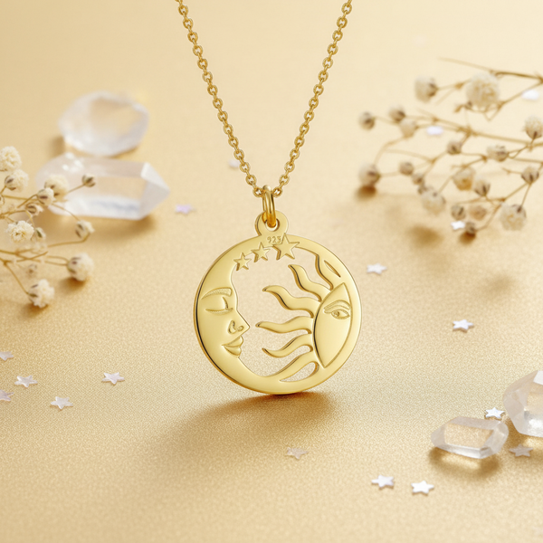 Gold necklace with a sun, a moon and stars design pendant on a beige background with crystals and flowers.