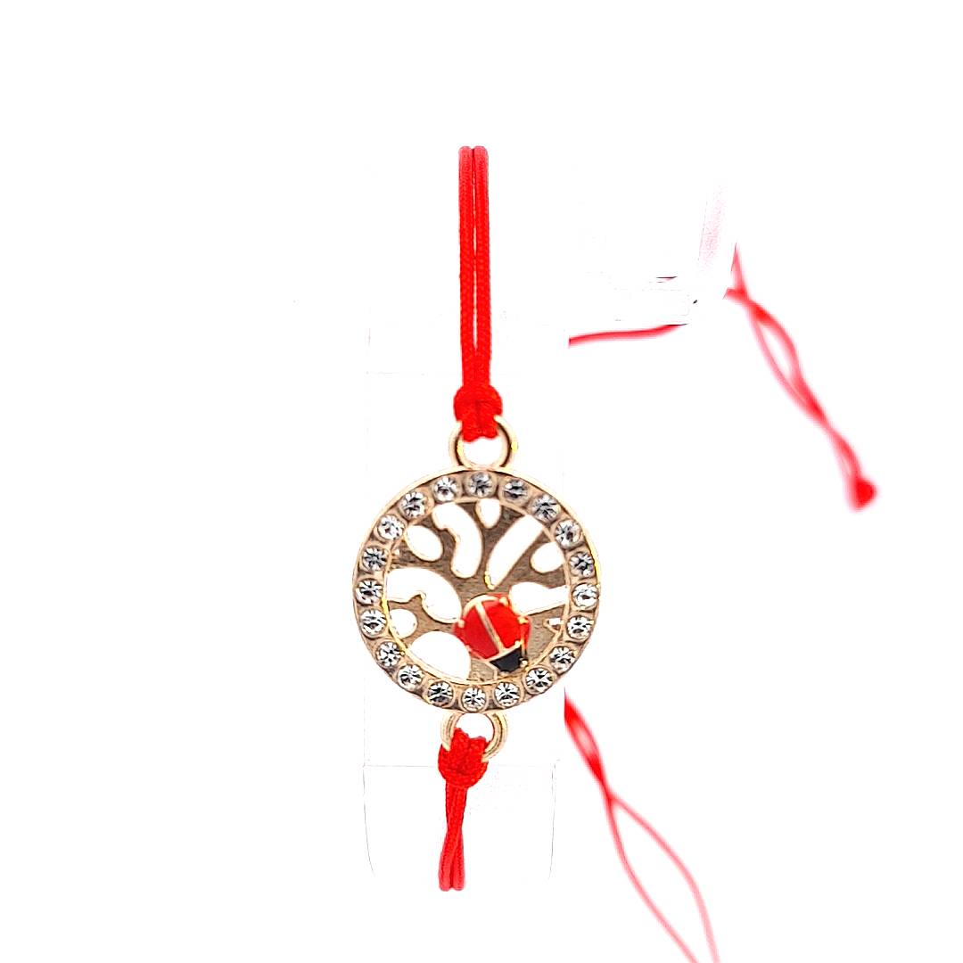 Close-up of the 'Vitality Spark' Martisor Bracelet's Tree of Life charm, featuring a red enamel ladybird and the surrounding crystals against the gold plating.