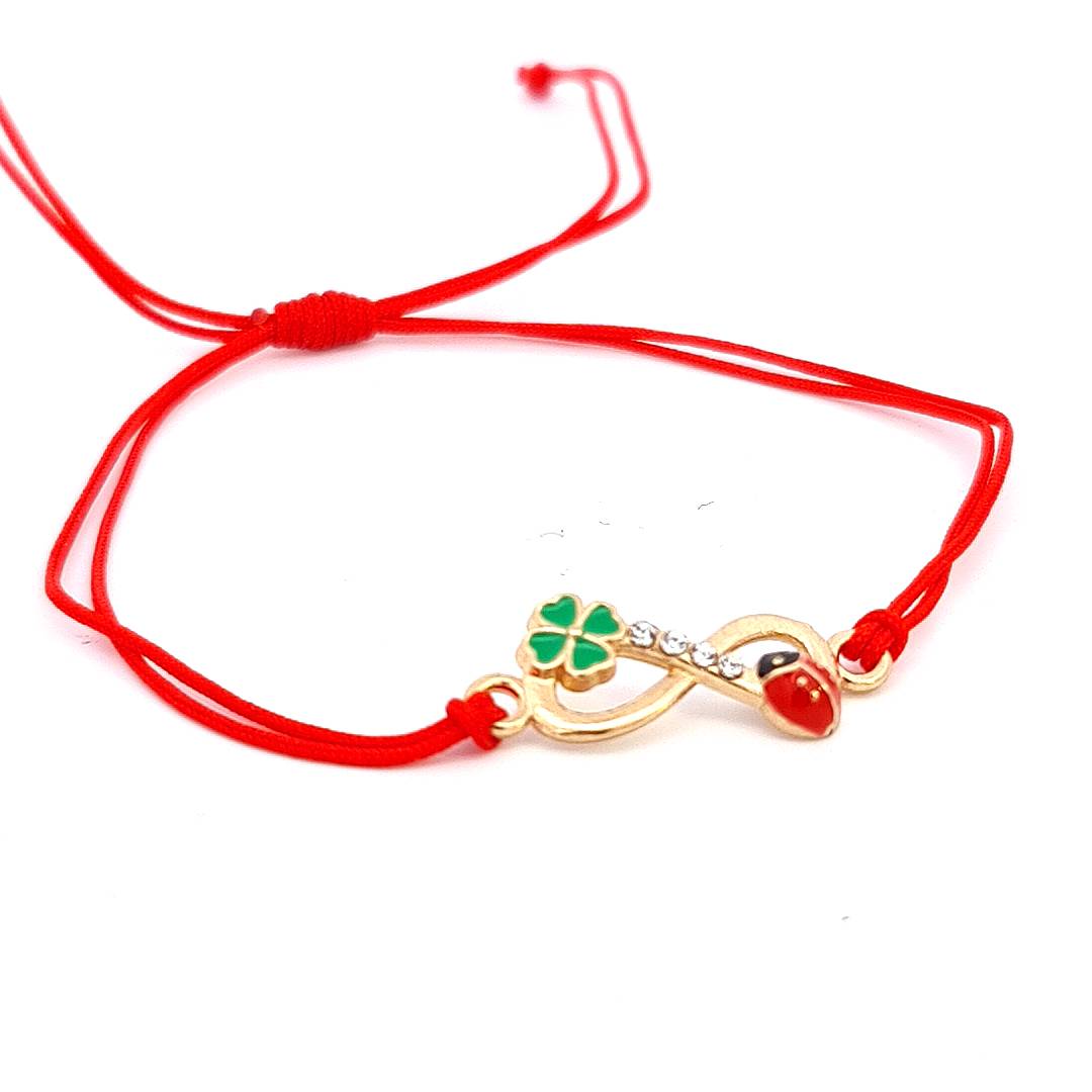 Detailed view of the 'Eternal Luck' Martisor Bracelet's infinity symbol with a ladybird and four-leaf clover charms, highlighting the enamel and crystal details.