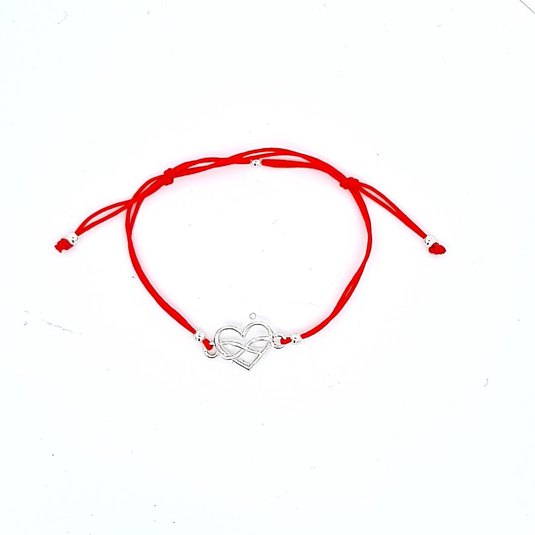 Red cord bracelet with adjustable slip-knots, and a heart with infinity intertwined connector in sterling silver 925 from Ireland, silver bracelet handmade by Magpie Gems, and small Irish jewellery designer