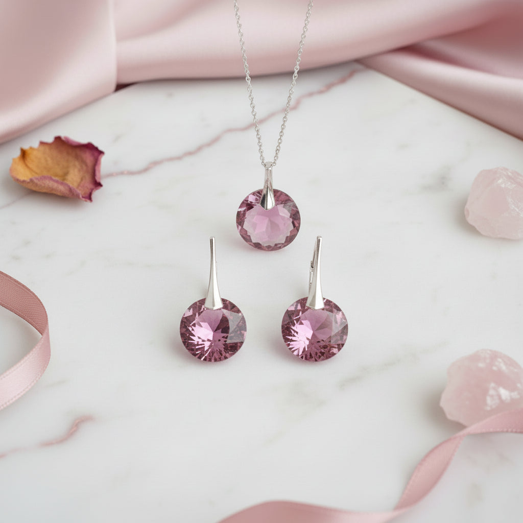 Pink Rose birth stone jewellery set on a marble surface with pink satin fabric