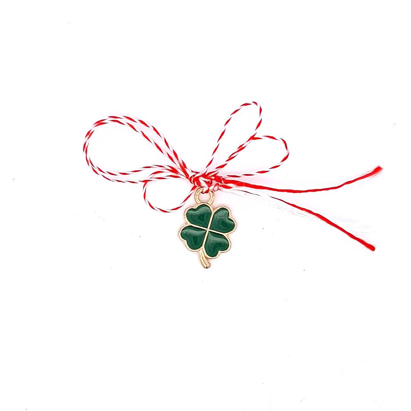 Front view of the 'Emerald Clover Wish' Martisor charm, featuring a gold-plated four-leaf clover with green enamel.