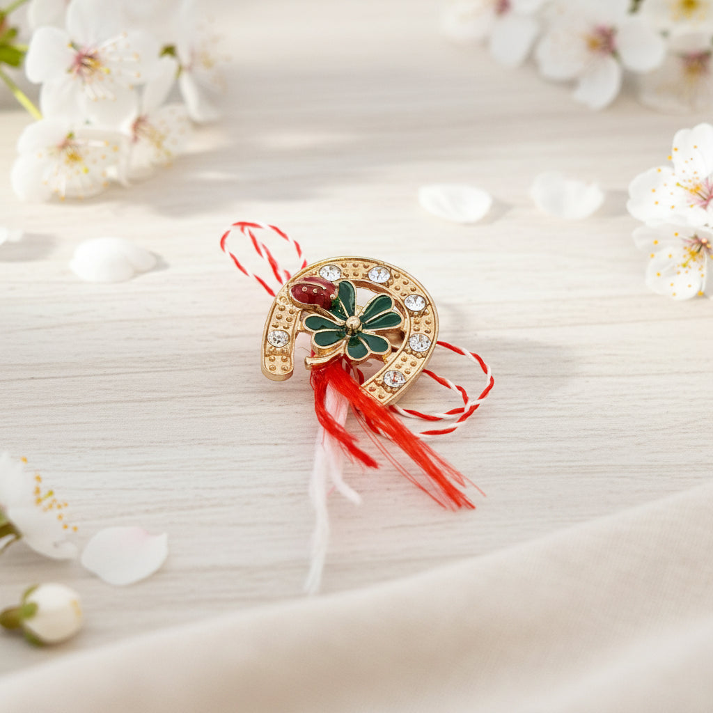 Front view of the 'Lucky Clover Horseshoe' Martisor brooch featuring a green enamel clover and crystal embellishments on a gold-plated setting.