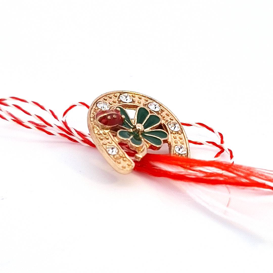 Side view of the gold-plated 'Lucky Clover Horseshoe' brooch, highlighting the detailed enamel work and crystal accents.