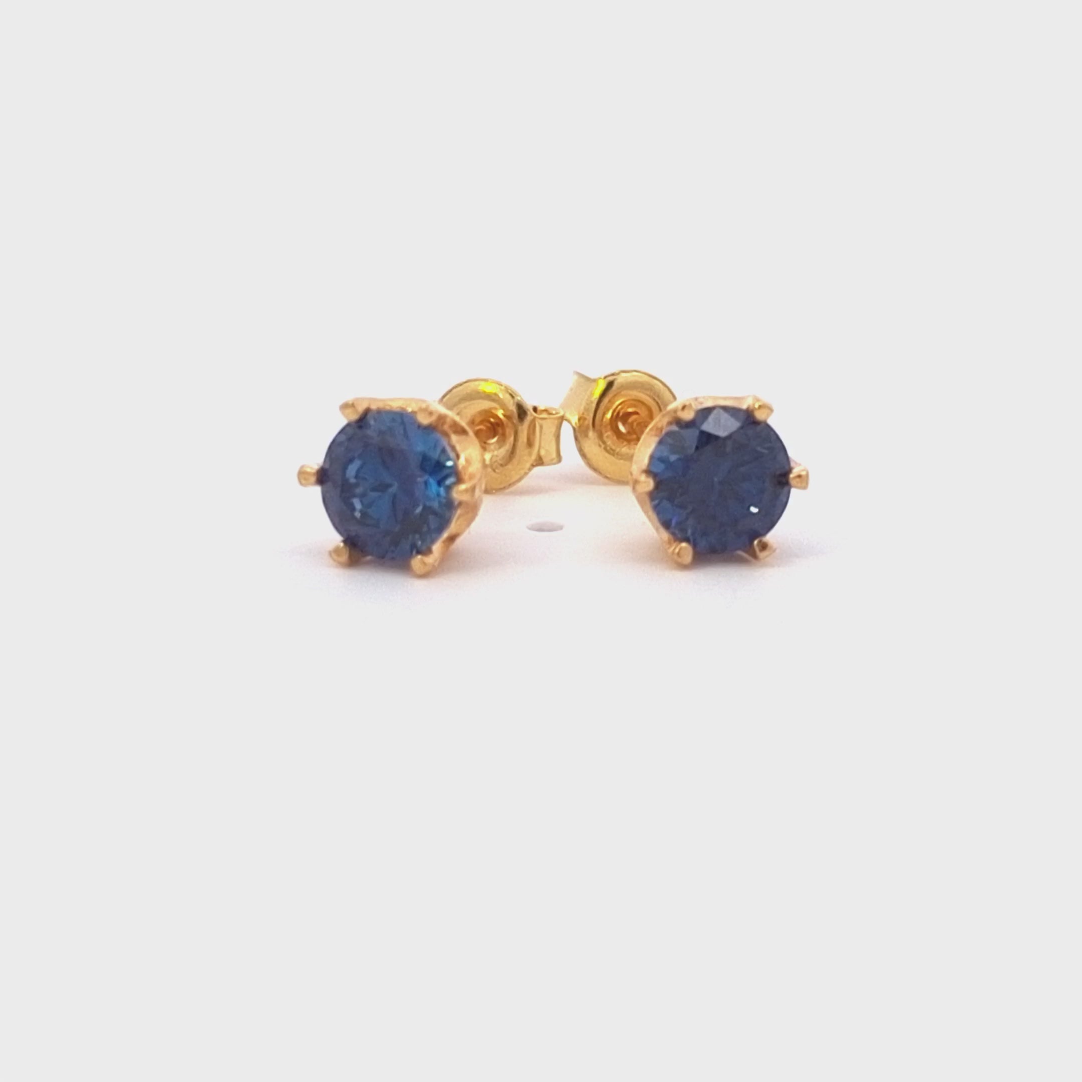 Royal blue Cubic Zirconia gold earrings detailed in motion, studs made for women and girls in Ireland.