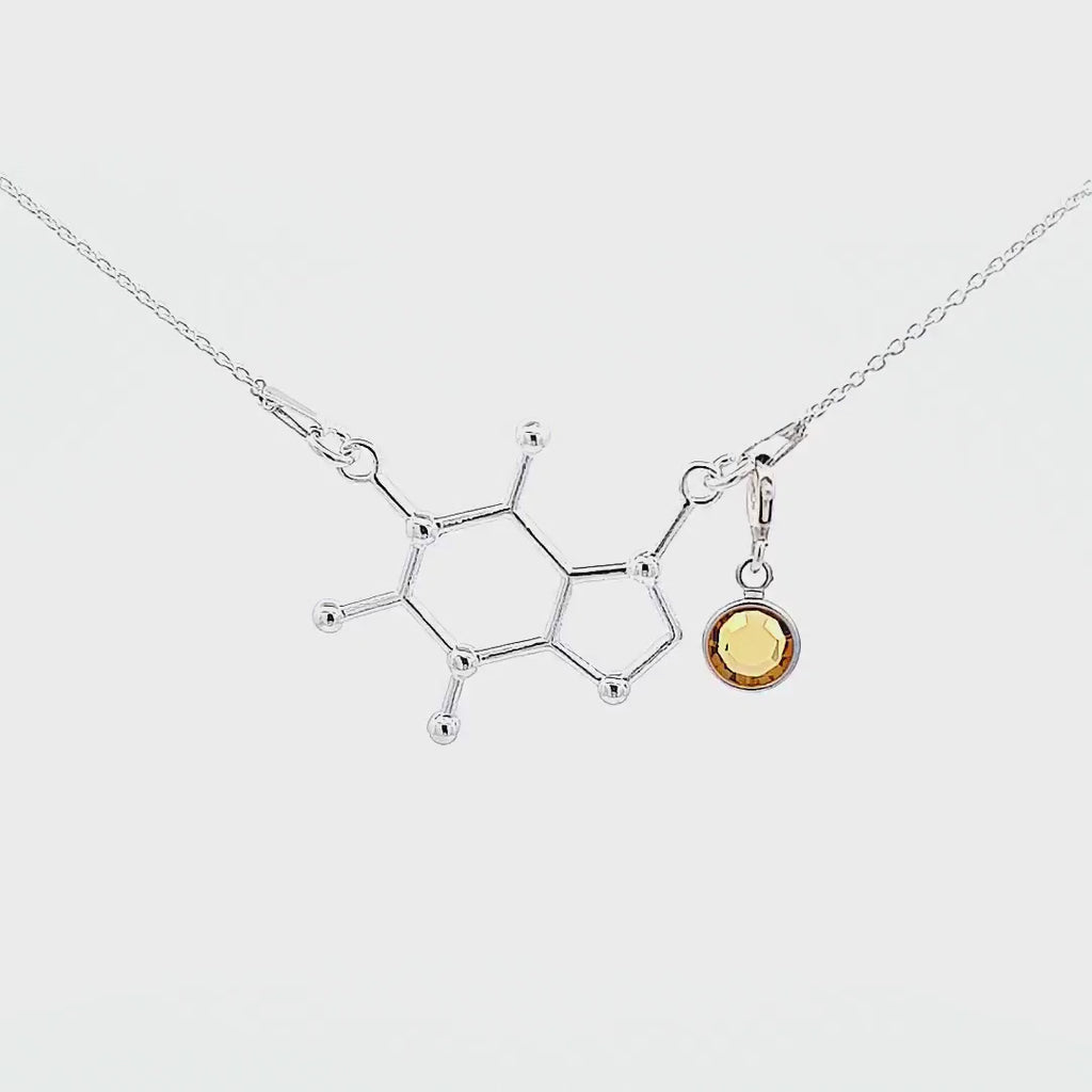 A video showcasing the beauty of a sterling silver necklace 925 with a coffee or cafeine molecule inspired by science, shop in Ireland