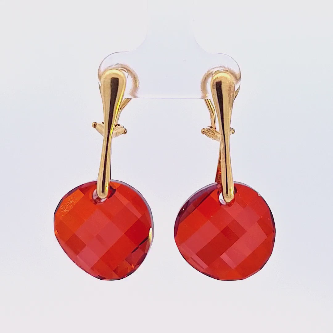 90-degree showcase video of the Crimson Cascade Gold Twist Clip-On Earrings, illuminating the fiery Red Magma Austrian crystals and rich gold finish.