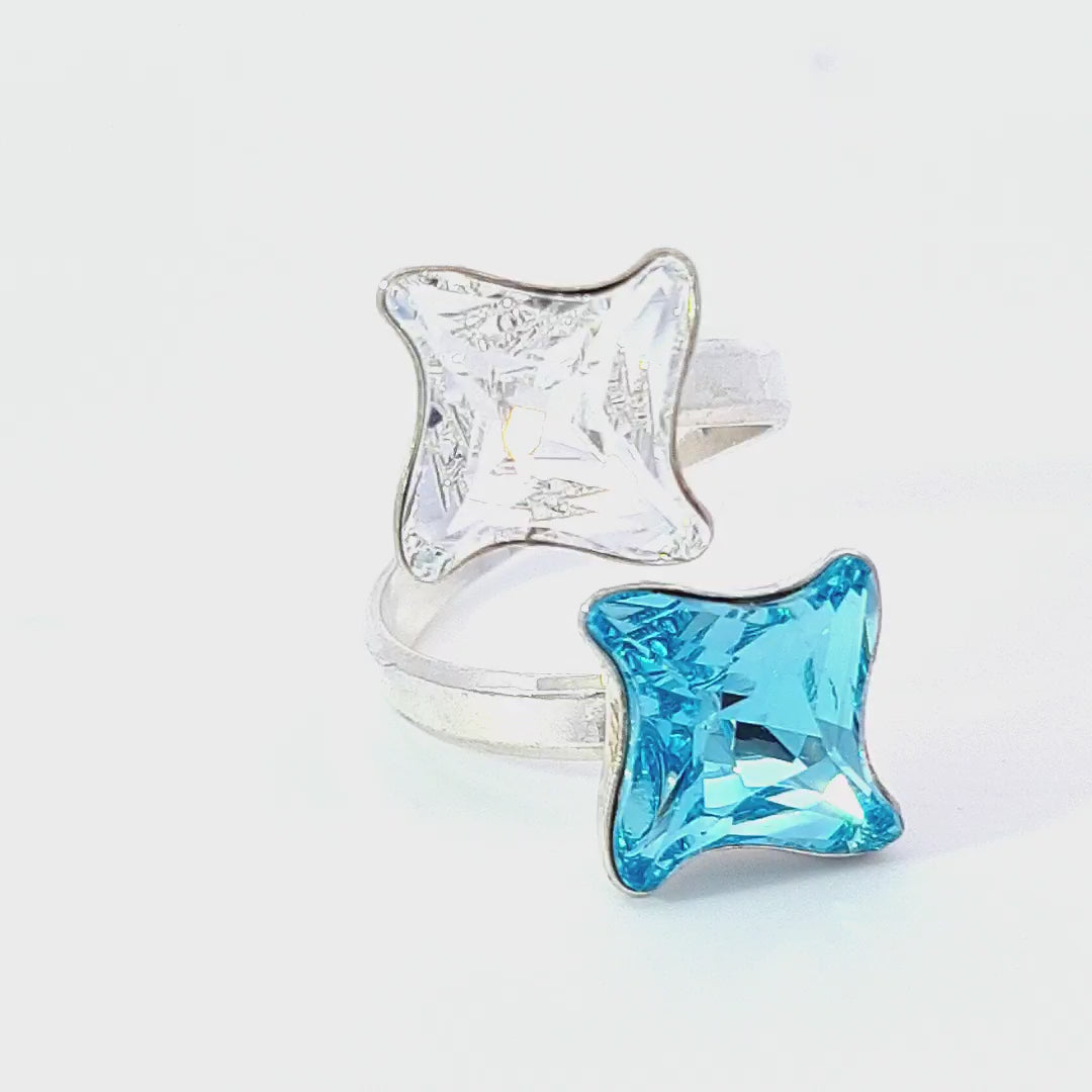 Discover the enchanting Stellar Twirl Open Star Ring, handcrafted with precision by Magpie Gems, featuring sparkling Austrian Twister crystals in Aquamarine and Crystal Clear.