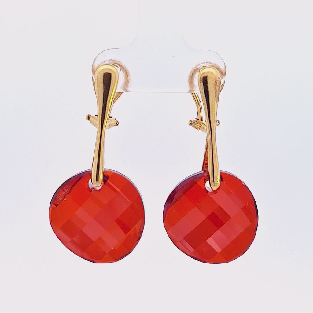 Showcase video of the Crimson Cascade Gold Twist Clip-On Earrings, illuminating the fiery Red Magma Austrian crystals and rich gold finish.