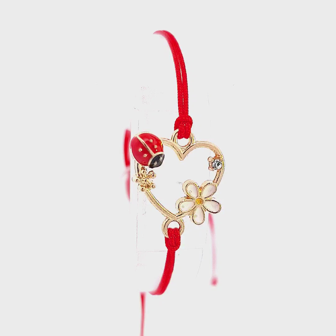 Showcase video of the 'Heartfelt Blossom' Martisor Bracelet, focusing on the gold-plated charms and demonstrating how to adjust the red macramé cord.