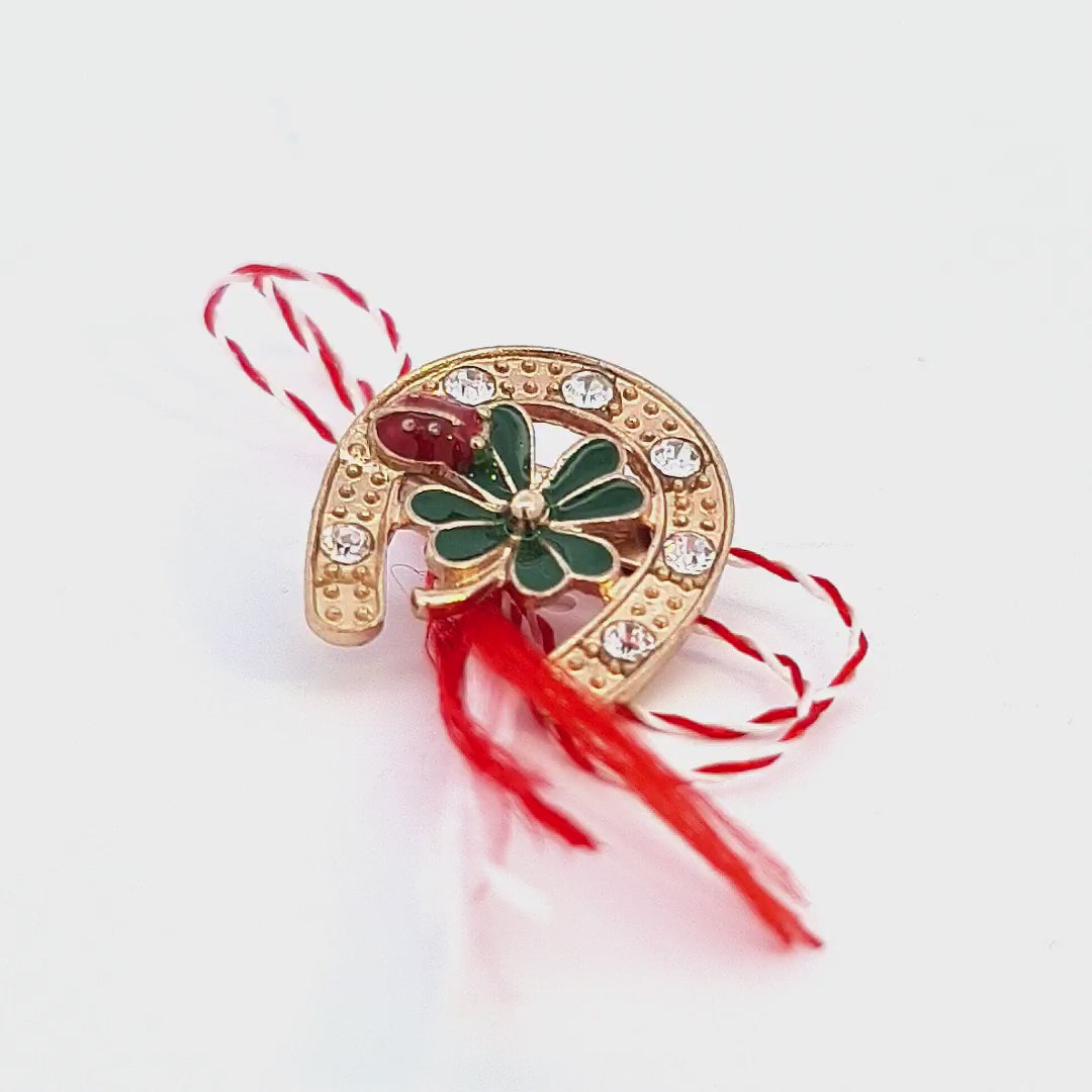 Showcase video of the 'Lucky Clover Horseshoe' Martisor brooch, illustrating the brooch's gold plating, green enamel clover, crystal details, and lucky ladybug feature from various angles.