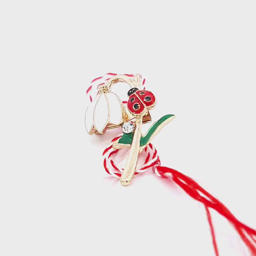 This video brings the Spring's Herald Martisor Brooch to life, showcasing its detailed craftsmanship and the vibrant colours of the enamel ladybug and snowdrop set against the traditional red and white string.