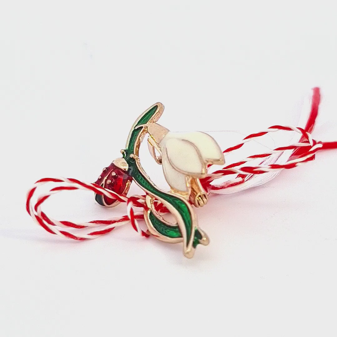 Video of the The 'Whispers of Spring' Martisor brooch with traditional Martisor string, ready to celebrate the spring season.