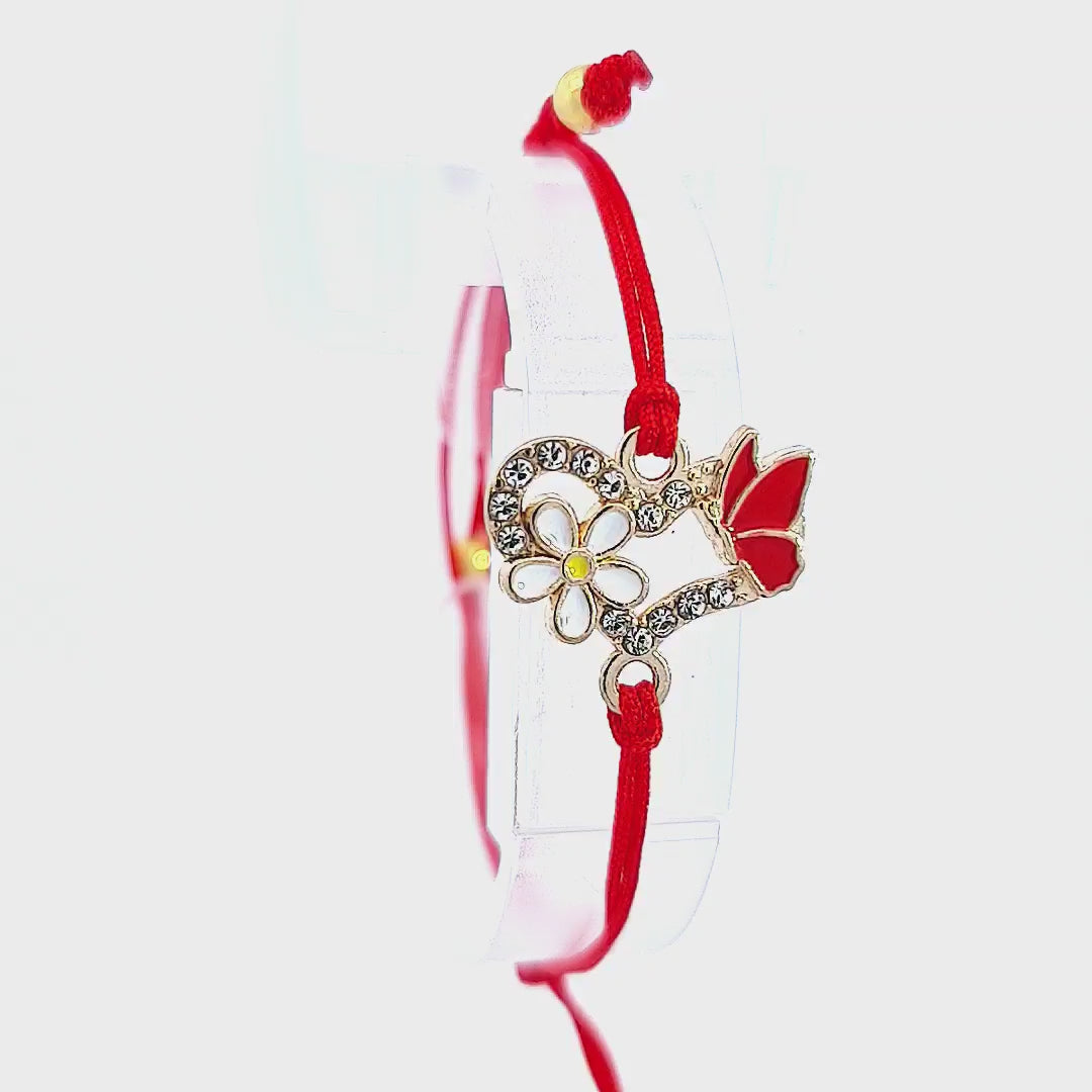 Video showcasing the 'Spring Harmony' Martisor Bracelet, capturing the light reflecting off the crystals and the detailed charms, with the red macramé cord's adjustability feature demonstrated, all against a white background.