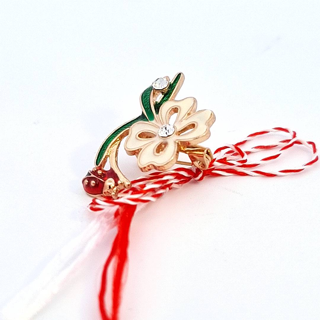 Side view of the 'Springtime Bloom' Martisor brooch showing the enamel depth and crystal detail.